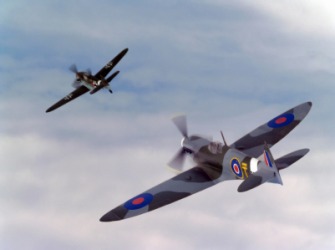 A dogfight between two World War II era planes. A dogfight between two World War II era planes.