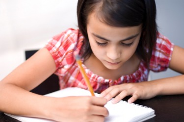 A girl doing her homework. A girl doing her homework.