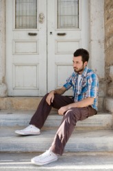 A man sitting on his doorstep. A man sitting on his doorstep.