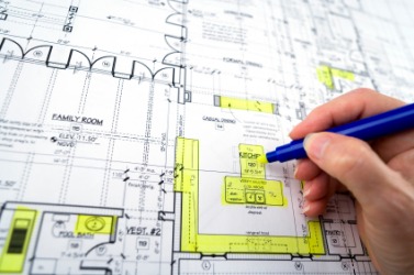 A draftsman at work on a houseplan. A draftsman at work on a houseplan.