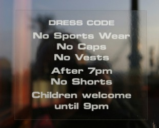 A bar displays its dress code. A bar displays its dress code.