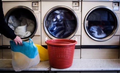 Dryables being taken out of a clothes dryer. Dryables being taken out of a clothes dryer.