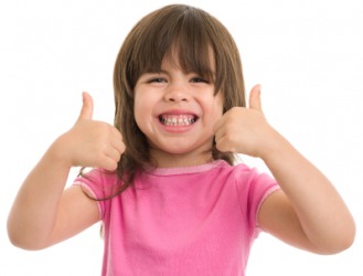 An eager child gives a double thumbs up. An eager child gives a double thumbs up.
