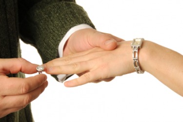 This man offers a woman a ring of engagement. This man offers a woman a ring of engagement.
