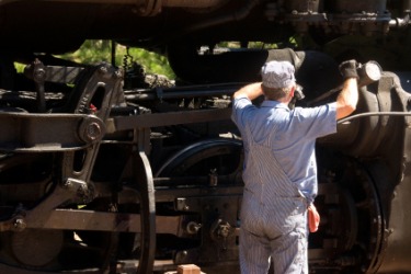 A railroad engineer working in his locomotive. A railroad engineer working in his locomotive.