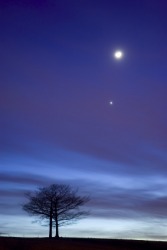 The evening star can be seen beneath the moon. The evening star can be seen beneath the moon.