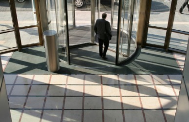 A man exits a building. A man exits a building.