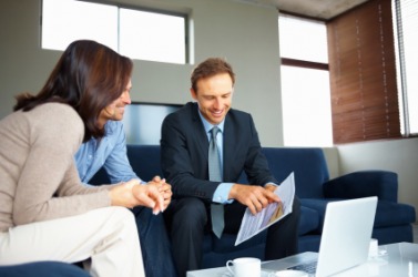 A man explains a document to his clients. A man explains a document to his clients.