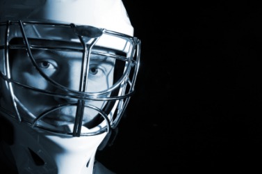 A hockey player wearing a face mask. A hockey player wearing a face mask.