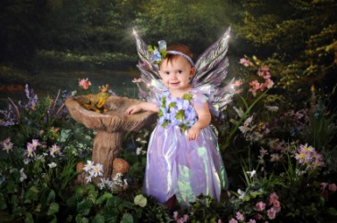 A child dressed as a fairy pretending to be in fairyland. A child dressed as a fairy pretending to be in fairyland.