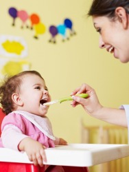 A mother feeding her baby. A mother feeding her baby.