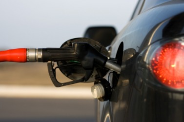 Getting a fill-up at a gas station. Getting a fill-up at a gas station.
