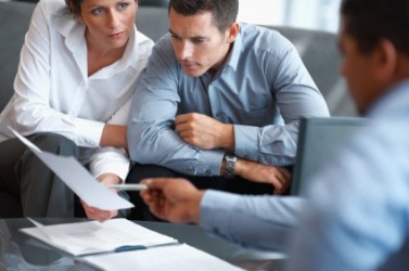 A couple receiving advice from their financial planner. A couple receiving advice from their financial planner.