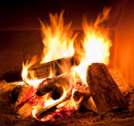 Firewood being burned in a fireplace. Firewood being burned in a fireplace.