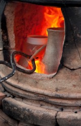 Firing pots in a kiln. Firing pots in a kiln.