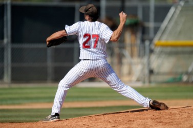 A pitcher about to fling the ball. A pitcher about to fling the ball.