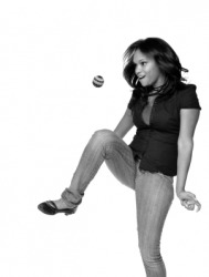 A woman playing with a footbag. A woman playing with a footbag.
