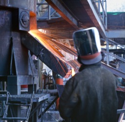 A man working in a foundry. A man working in a foundry.