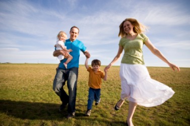 A family frolics in a field. A family frolics in a field.