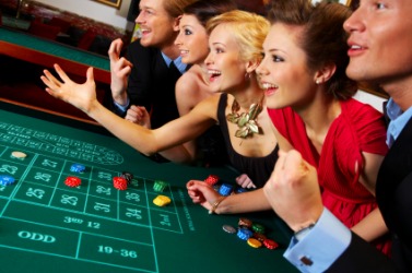 A group of people who have come to a casino to gamble. A group of people who have come to a casino to gamble.