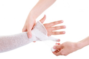 An arm being wrapped in gauze. An arm being wrapped in gauze.