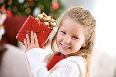A little girl has received a gift. A little girl has received a gift.