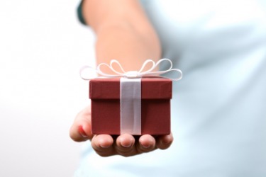 A woman gives a gift. A woman gives a gift.