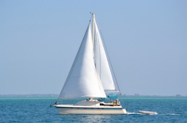 A sailboat glides across the water. A sailboat glides across the water.