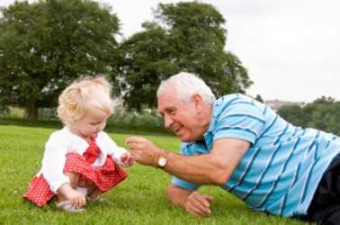 A man plays with his grandchild. A man plays with his grandchild.