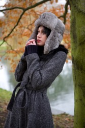 A woman wearing a greatcoat. A woman wearing a greatcoat.