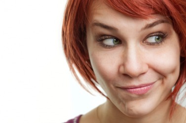 A young woman grimaces. A young woman grimaces.