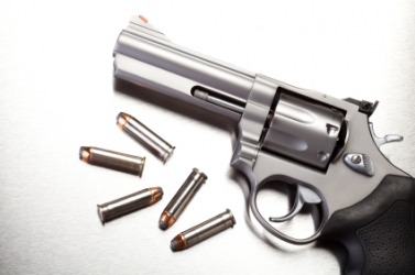 A gun with bullets. A gun with bullets.