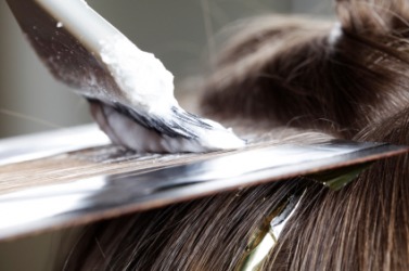 A woman has a hairdressing applied. A woman has a hairdressing applied.
