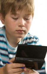 A boy uses a hand-held video game. A boy uses a hand-held video game.