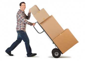 A man uses a hand truck to move boxes. A man uses a hand truck to move boxes.