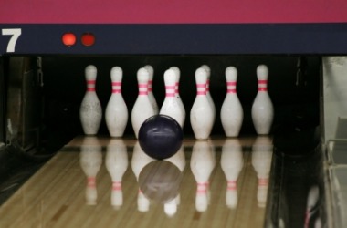 A bowling ball about to strike a headpin. A bowling ball about to strike a headpin.