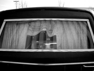 The rear window of a hearse. The rear window of a hearse.
