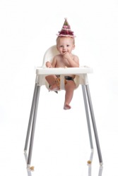 A baby sitting in a highchair. A baby sitting in a highchair.