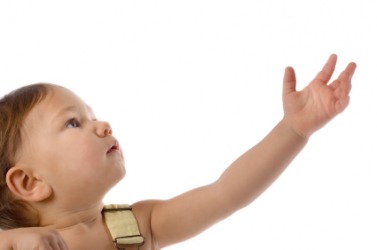 A child holds out her hand imploringly. A child holds out her hand imploringly.