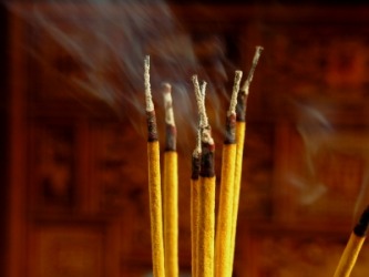 Several sticks of burning incense. Several sticks of burning incense.