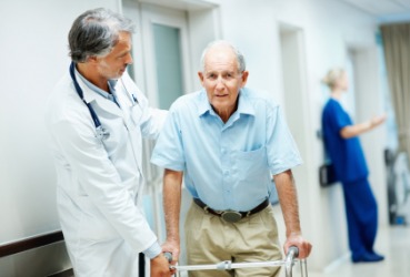 A doctor assists an infirm man. A doctor assists an infirm man.