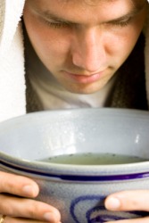 A man uses the inhalation of steam for his cold. A man uses the inhalation of steam for his cold.