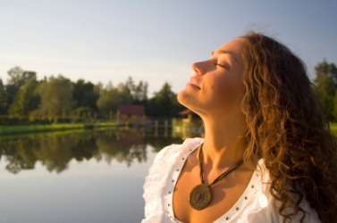 A woman inhales the morning air. A woman inhales the morning air.