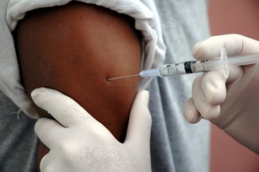 A person recieves an injection. A person recieves an injection.