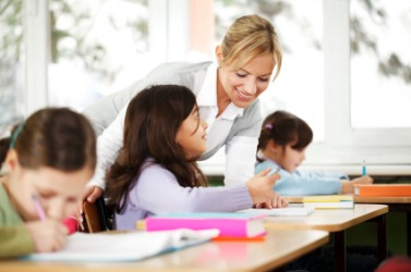 A teacher instructs her class. A teacher instructs her class.