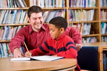 A boy receives instruction from his teacher. A boy receives instruction from his teacher.