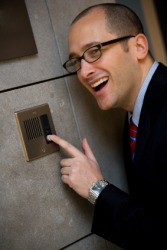A man using an intercom. A man using an intercom.