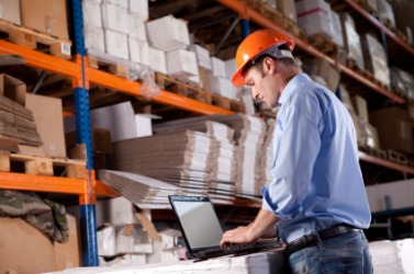A businessman checks his warehouse inventory. A businessman checks his warehouse inventory.