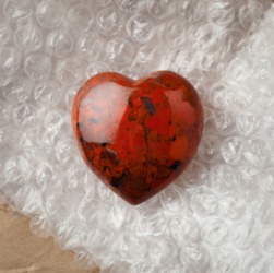 A piece of jasper in the shape of a heart. A piece of jasper in the shape of a heart.