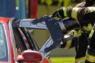 An emergency worker uses the Jaws of Life. An emergency worker uses the Jaws of Life.
